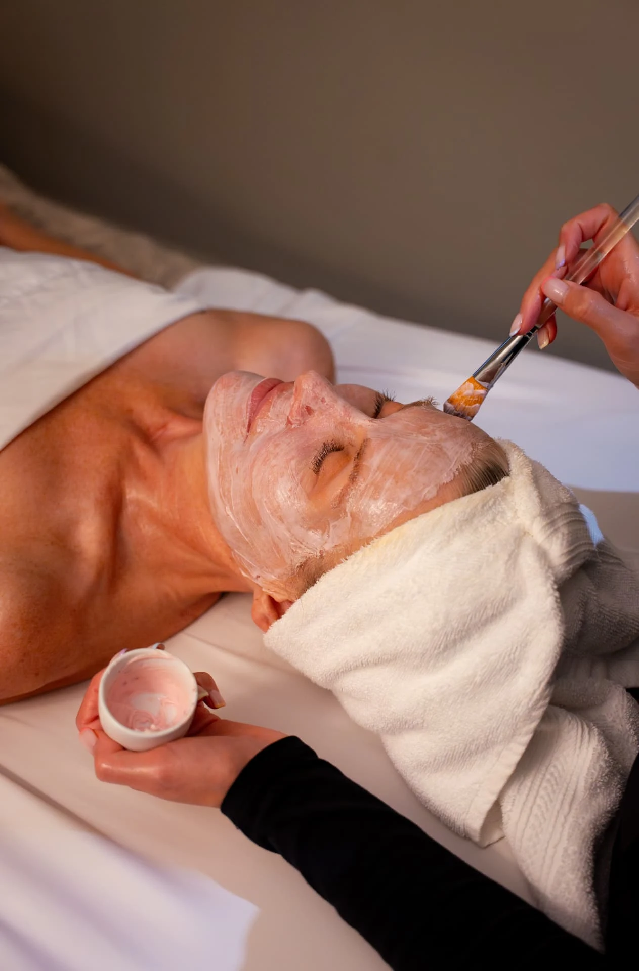 Guest receiving a facial treatment at a resort spa