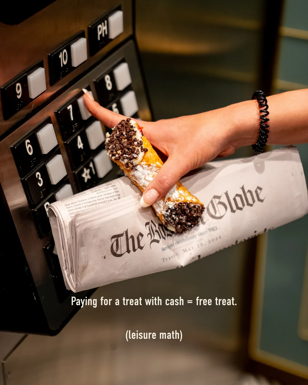 Cannoli wrapped in a newspaper: paying for a treat with cash means a free treat