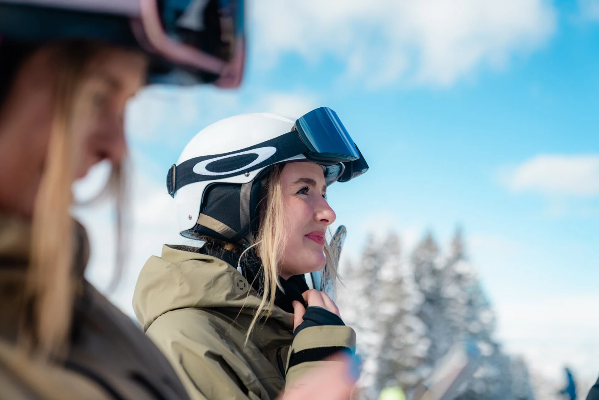 Skier in helmet and goggles on a sunny mountain